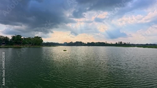 Aerial view of Sutami Dam at sunset with golden reflections on the reservoir water