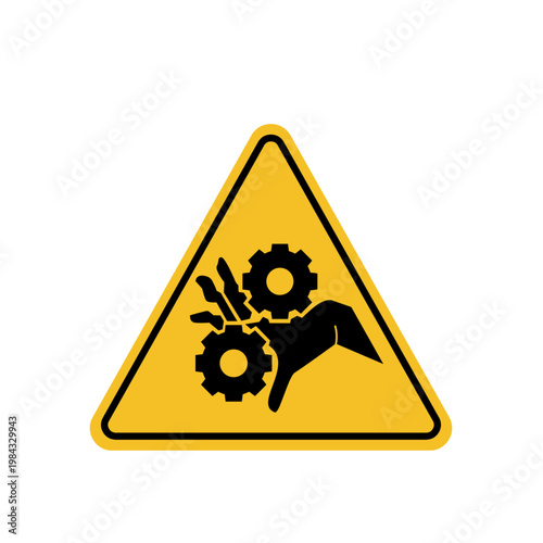 Caution sign with hand caught in industrial gears and bird silhouette on yellow background
