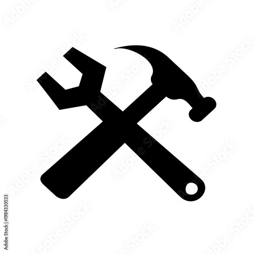Black silhouette of crossed hammer and wrench on white background symbolizing tools and construction
