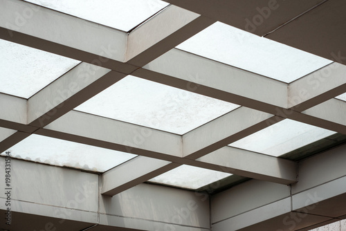 Schilderij op canvas Modern geometric skylight ceiling architectural structure with metal beams and frosted glass