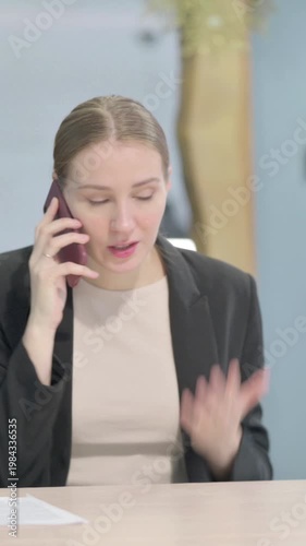 Wallpaper Mural Upset Businesswoman Talking Angrily on Smartphone, Vertical Video Torontodigital.ca