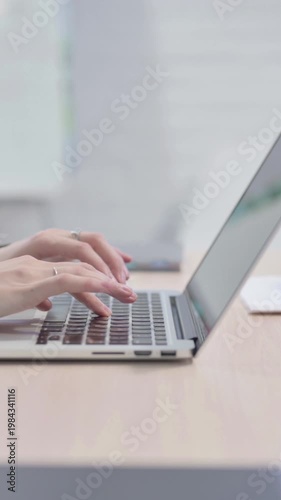 Wallpaper Mural Side View of Female Hands Typing on Laptop, Vertical Video Torontodigital.ca