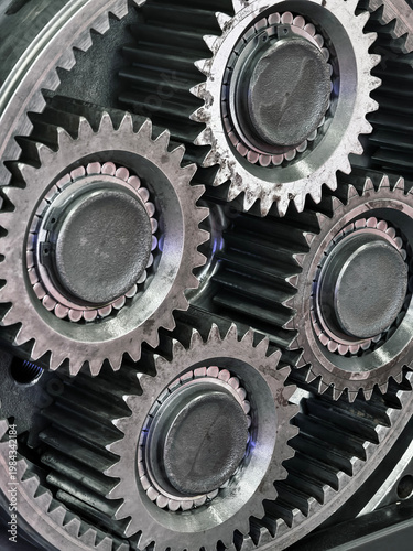 Photos Close view of four metal gears in a mechanical system showing details of teeth a