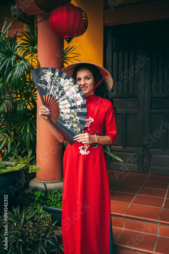 A woman in a national Vietnamese costume in the ancient city of Hoi An.