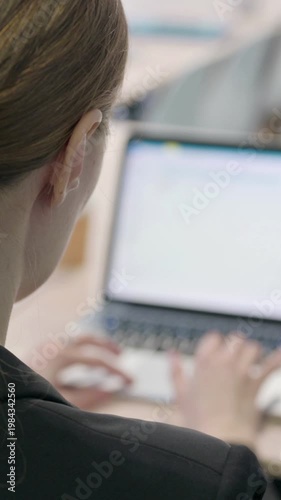 Wallpaper Mural Businesswoman Working on Laptop in Office, Vertical Video Torontodigital.ca