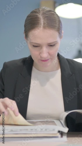Wallpaper Mural Businesswoman Reading Magazine at Work, Vertical Video Torontodigital.ca