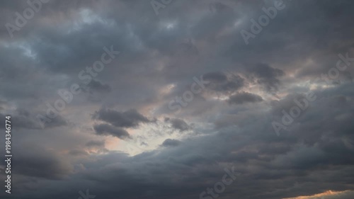 Time-lapse view of dramatic clouds with shifting light effects in the sky.
