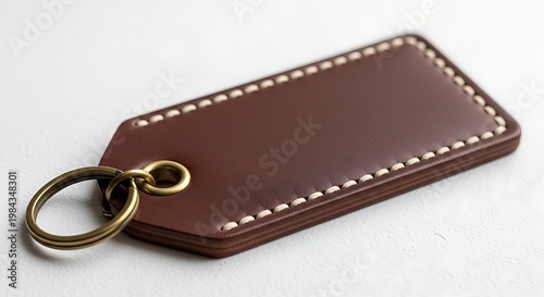 Premium brown leather keychain luggage tag with white hand stitching and vintage brass ring on white background, keychain