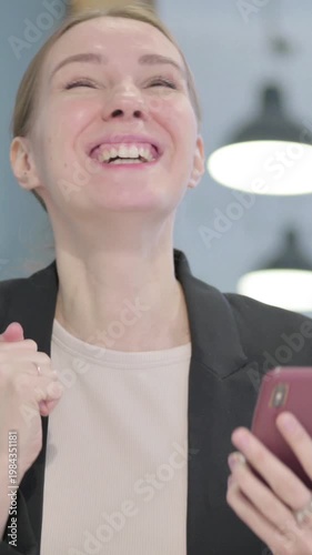 Wallpaper Mural Excited Businesswoman Celebrating Win on Smartphone, Vertical Video Torontodigital.ca