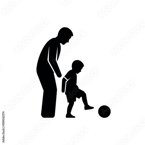 Father and son playing soccer silhouette.