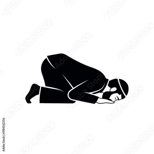 Silhouette of a Muslim man praying in prostration.