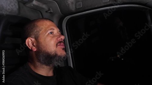 Delivery driver sings while driving at night to stay awake during long hours. The scene highlights fatigue management and human behavior.