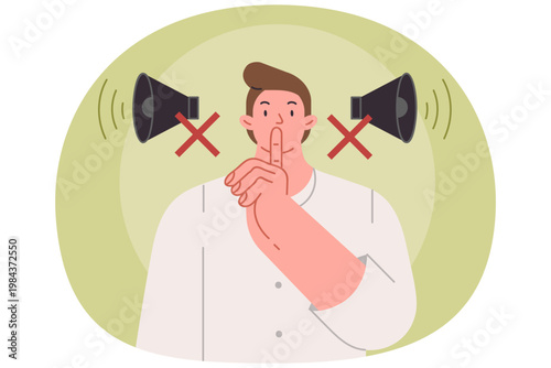 Man makes tss gesture urging him to switch phone to airplane mode and speak in whisper