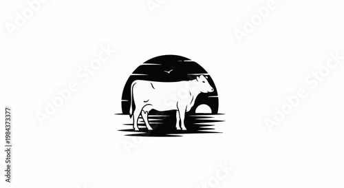 Silhouette of a cow in front of a setting sun over water