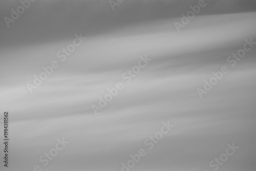 Gray background, gray sky and clouds in the photo in the form of various lines and stripes with gradient transitions