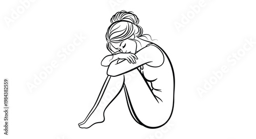 A sad woman sits curled up head bowed in despair