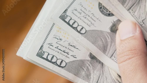 Close up Hands Counting Stack of US Dollar Banknotes