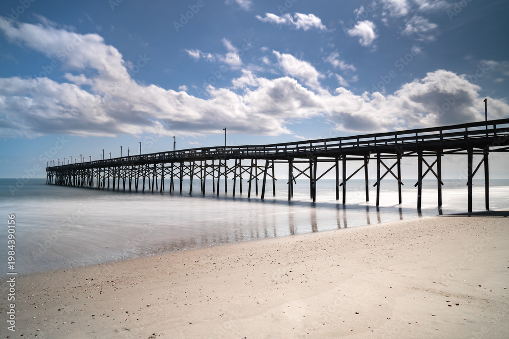 Fototapeta premium view of the Ocean Isle Beach Pier on a beautiful spring afternoon