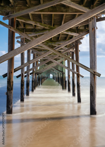 view from underneath the Ocean Isle Beach Pier on a spring afternoon
