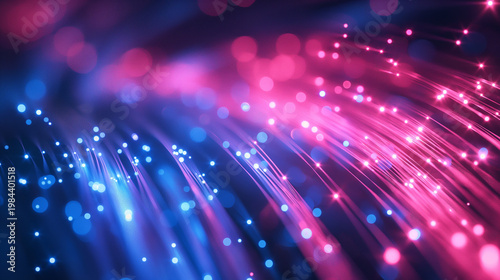 Fiber Optics: An abstract close-up shot of fiber optic cables glows with radiant pink and blue lights, symbolizing connectivity, data transfer, and technological advancement.