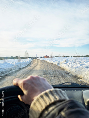 Driving down a dirt road on a journey through a winter landscape with snow on the sides