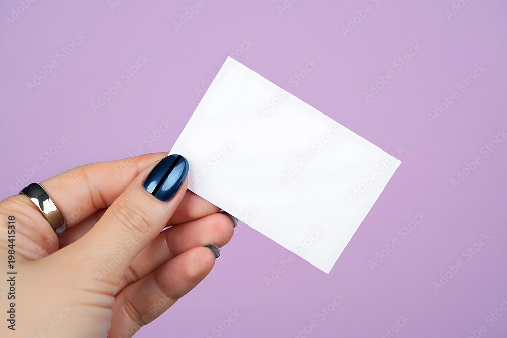 Obraz premium Hand holding blank white card against lavender background image