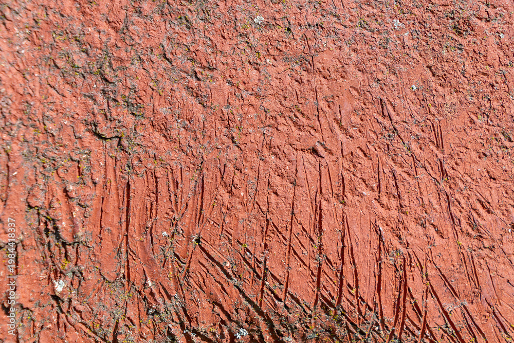 Fototapeta premium Red painted surface with scratches and rough texture