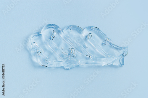Tableau sur toile Close up of transparent cosmetic gel swatch with air bubbles on soft blue background