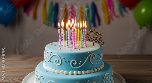 Two-tiered blue birthday cake with lit candles and festive decorations.
