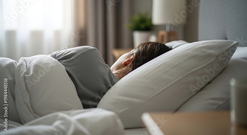 Woman Sleeping Peacefully in Cozy Bed with White Pillows