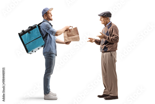 Courier handing food delivery bag to an elderly man