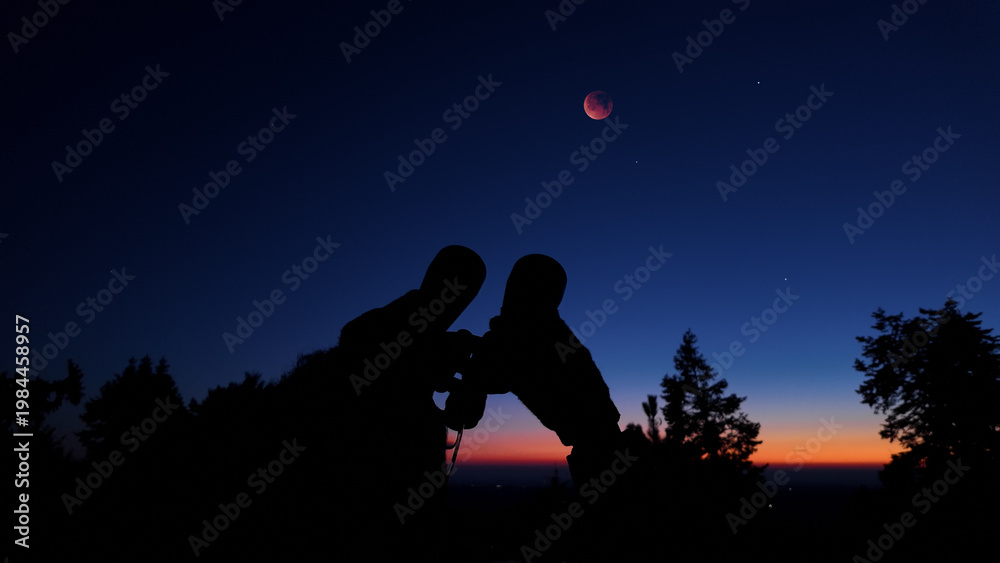 Fototapeta premium Amateur astronomer using binoculars for observing stars, planets, Moon and other celestial objects.