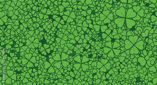 Dense seamless pattern of green four leaf clovers covering the entire frame for a lucky St Patricks Day themed background.
