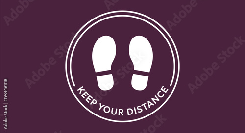 Circular floor sign in dark purple with footprints and keep your distance text for social distancing and public health safety measures.