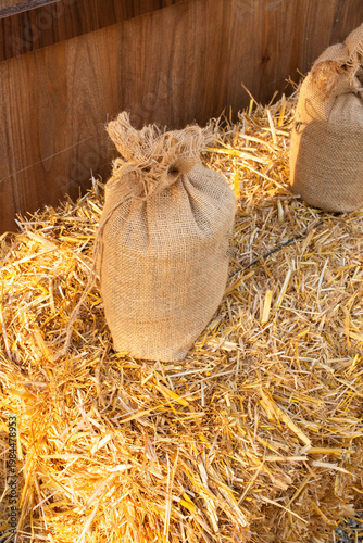 Rustic Burlap Sack Sitting on Yellow Hay Bale