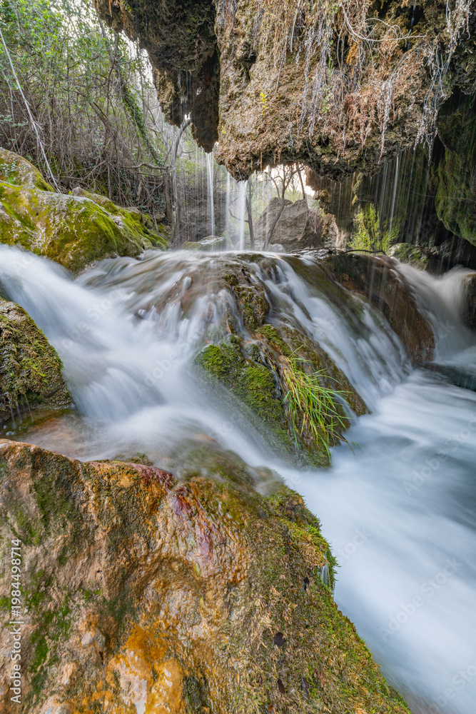 Fototapeta premium Smooth Silk Waterfall in Green Wilderness – Serenity and Nature Background
