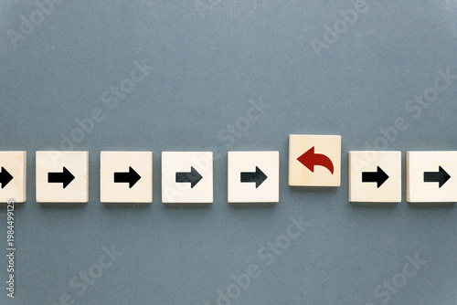 One arrow turns in the opposite direction, representing change, contrarian thinking, and strategic pivot in business or decision making