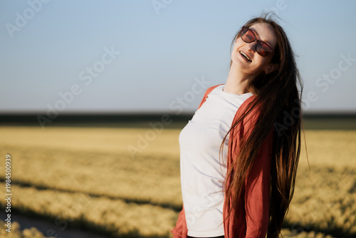 Beautiful Woman standing in colorful tulip flower fields in Amsterdam region, Holland, Netherlands. Magical Netherlands landscape with tulip field in Holland Trevel and spring concept