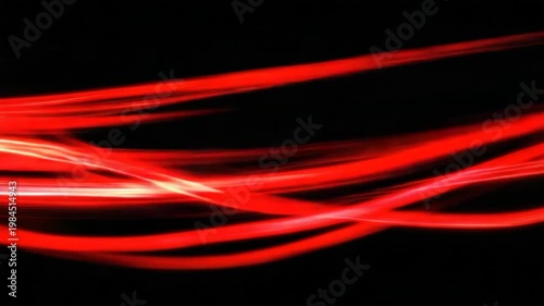 Swirling red light trails against a black backdrop, creating a sense of movement and energy