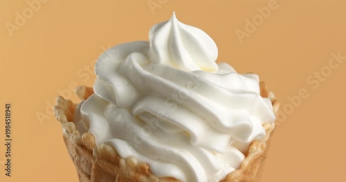 Vanilla ice cream in waffle cone close-up on the rotating table.