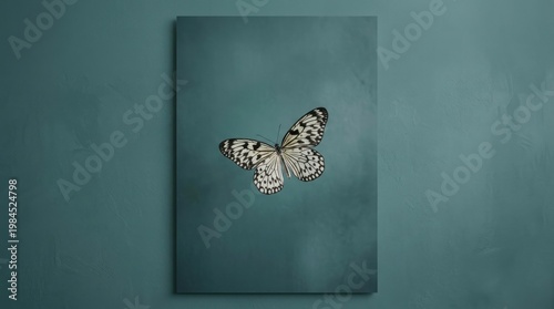 Monochrome teal wall art featuring delicate mounted butterfly.