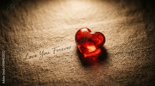 Glass heart keepsake on textured surface with handwritten love message.
