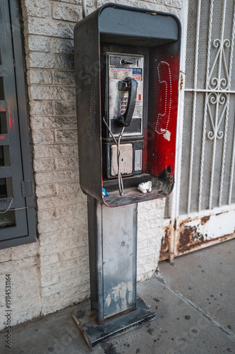 Old phone both on city streety