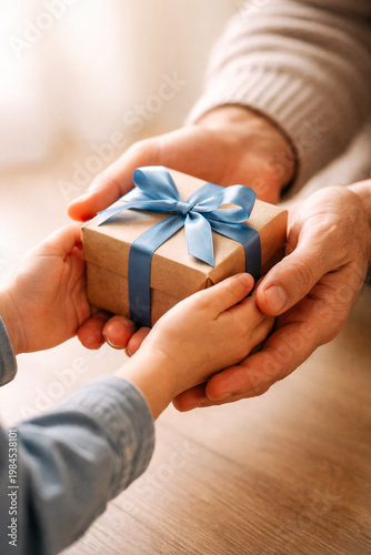 Close-up of father and child hands holding a gift box together, warm natural light and soft tones, emotional and minimalist composition for Father’s Day and family concepts.