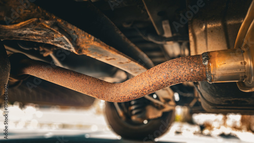 Fotografie a rusty exhaust pipe located underneath a vehicle
