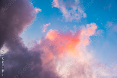Fairytale blue sky with sugar cotton pink cloud in a dreamy background. Morning dawn. Amazing heaven. Nature wallpaper. Idyllic backdrop. Romantic atmosphere. Textured abstract. High quality photo.