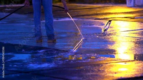 Farm worker cleaning up horse stable in the morning