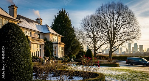 A snow-dusted estate with expansive gardens, trees, and a distant cityscape under a winter sky. A vehicle is parked near the estate