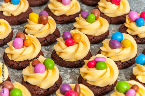 brown cookies with yellow cream and candies
