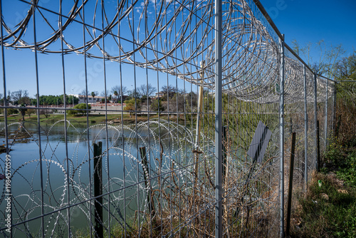 concertina wire next to the Rio Grande